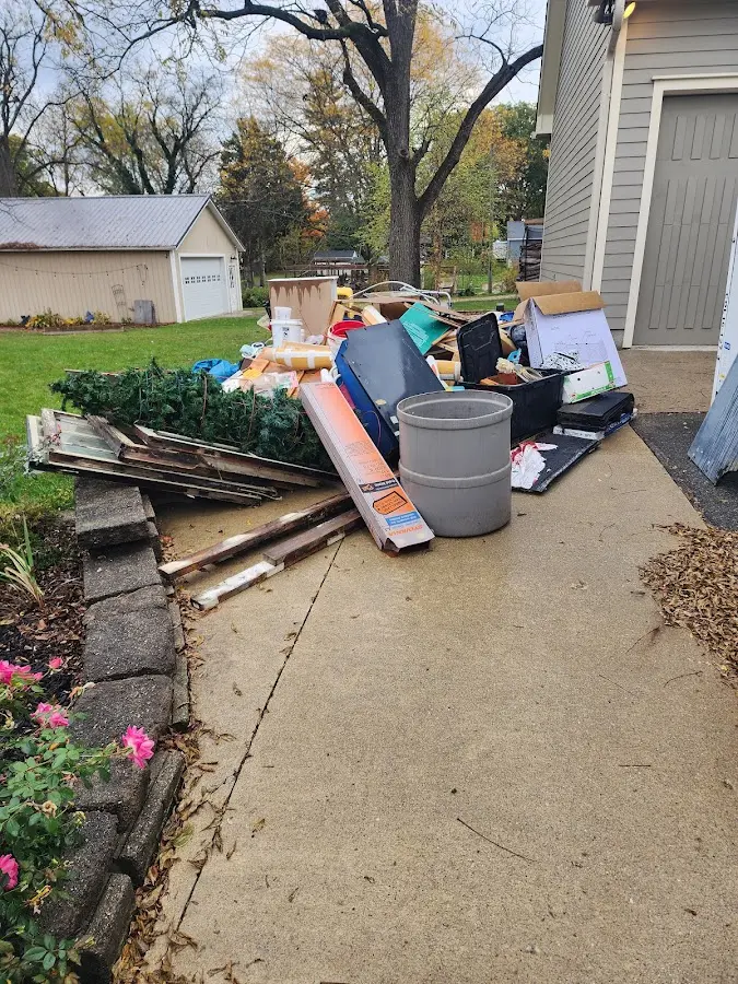 Dumpster being loaded with debris for Roofing Dumpster Rental in Eureka